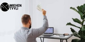 Mies istuu tietokoneen ääressä